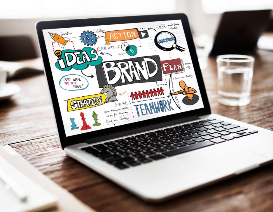 Adobe Stock Photo Photo of computer with branding brainstorming ideas and graphics