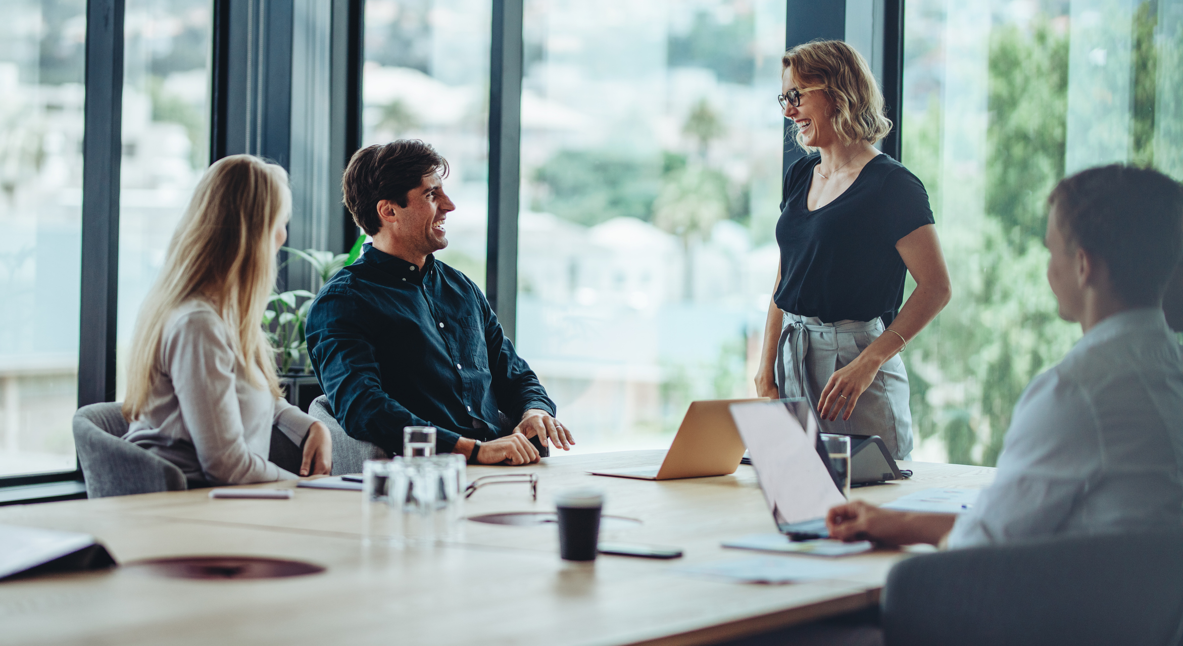 Photo of a group of happy corporate people in a business meeting.