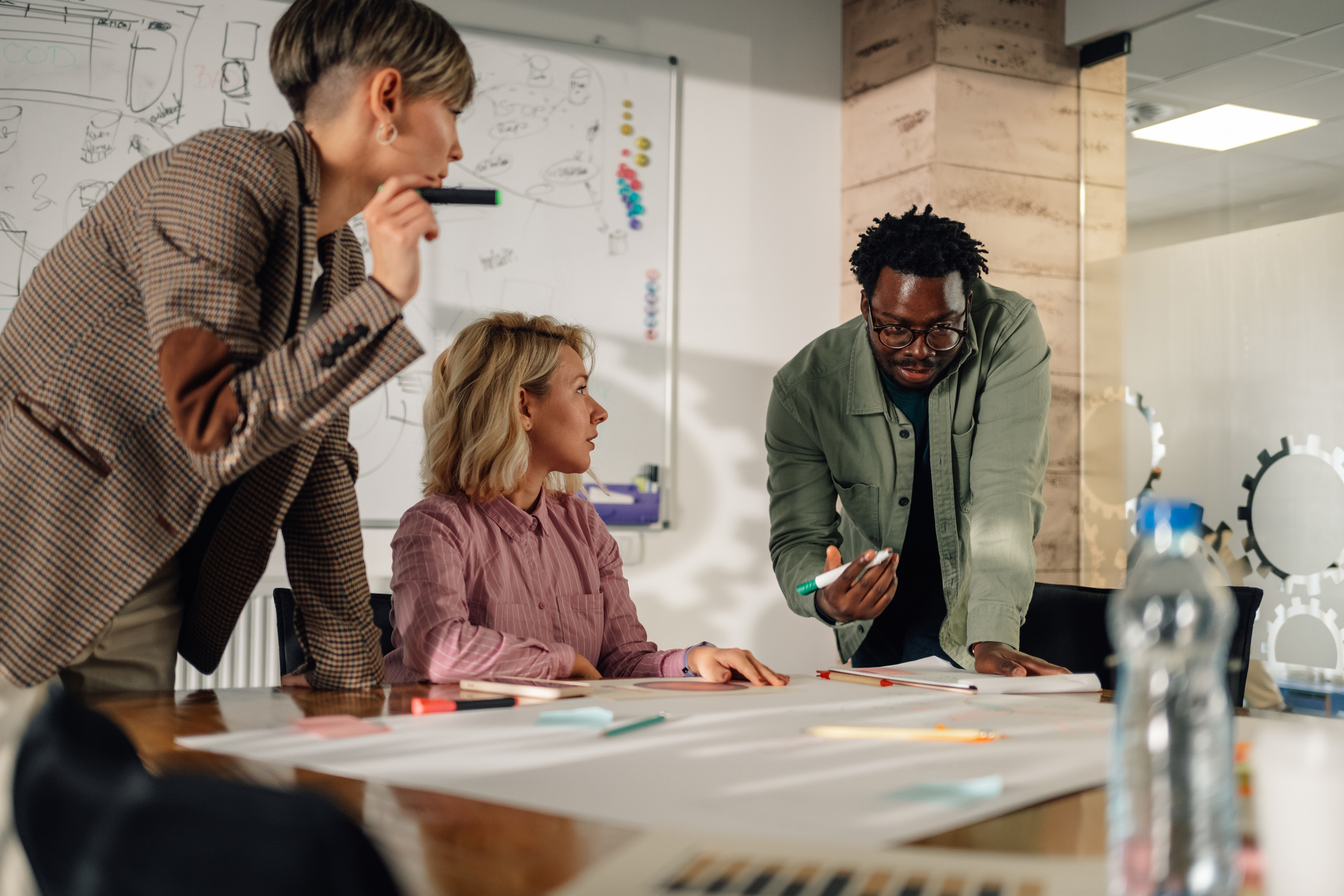 Three people who are working together on a project in an office setting.