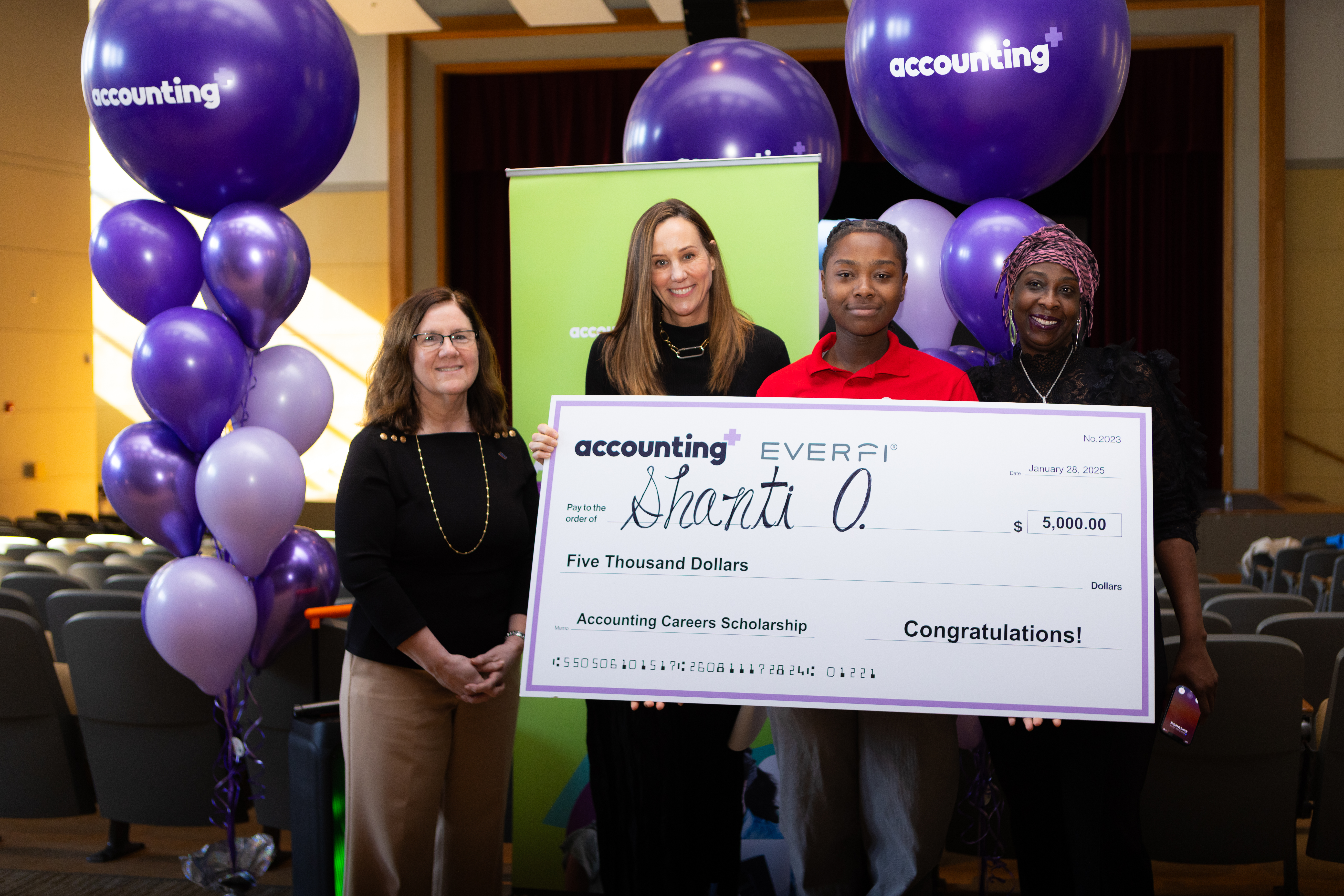 Presenting a student with a $5,000 scholarship at an Accounting+/EVERFI event.