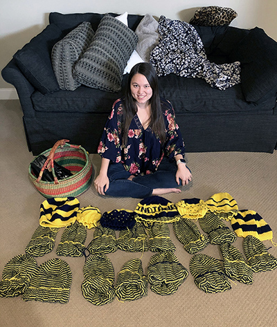Stephanie Ting with the hats she's been knitting for the Indiana Pacers’ Nothing But Knit project