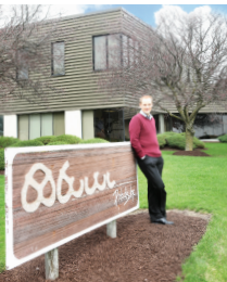 Taylor Aschliman in front of Pretzels, Inc.