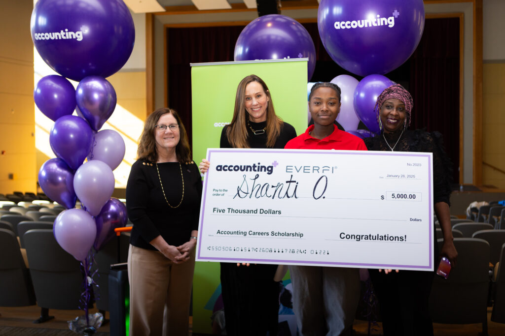 Presenting a student with a $5,000 scholarship at an Accounting+/EVERFI event.
