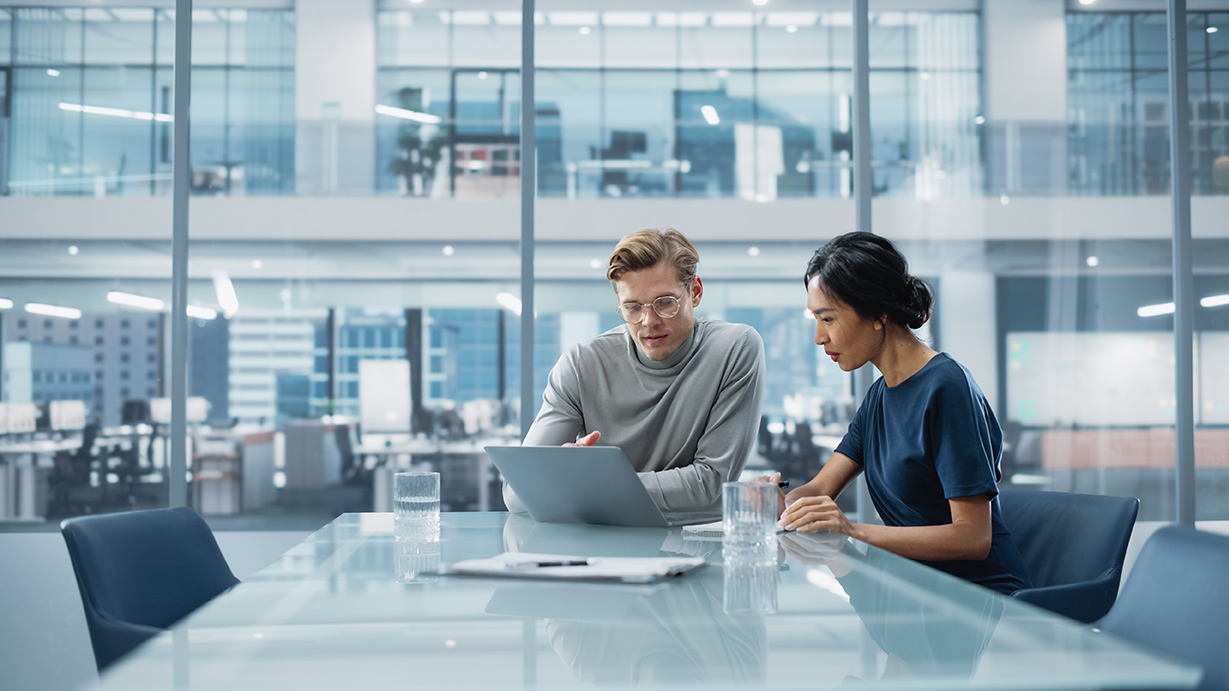 Photo of two people working in an office together